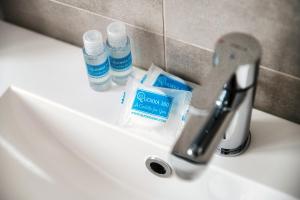 a bathroom sink with a toothbrush and toothpaste on it at Lario Suite Apartments by Quokka 360 - Close to Como Downtown in Como +69 photos