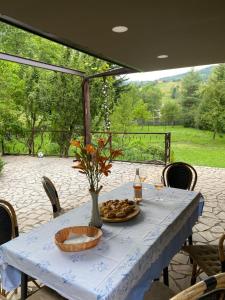 a blue table with a plate of food on it at Vila Garden River Jahorina - Sarajevo in Mokro