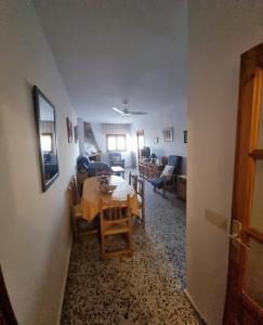 a dining room and living room with a table and chairs at Casa Holandesa in Pitres