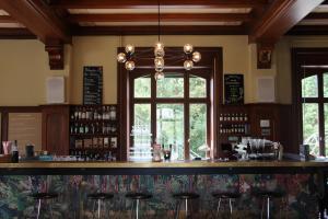a bar in a restaurant with stools at Militärkantine St. Gallen in St. Gallen