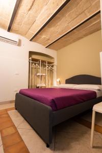 a bedroom with a large bed in a room at A casa di Edo in Matera
