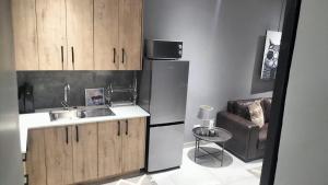 a kitchen with a sink and a refrigerator at J & M Elegant Escape in Centurion
