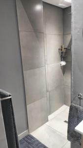 a shower with a glass door in a bathroom at J & M Elegant Escape in Centurion +16 photos
