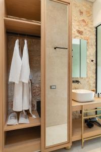 a bathroom with a mirror and a sink at The Alma City Hotel in Chania Town +92 photos