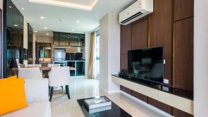 a living room with a flat screen tv and a couch at Apartment 2 bedrooms on Surin in Surin Beach