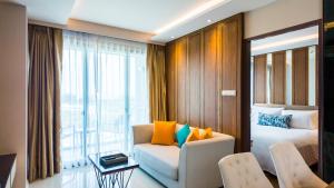 a hotel room with a bed and a couch at Apartment 2 bedrooms on Surin in Surin Beach
