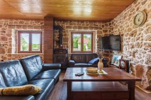 a living room with a couch and a table at Villa Stone Valcer in Slivno