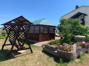 a garden with a statue and flowers in a yard at Hotel 7ya in Krasnosilske