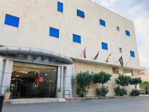 a building with blue windows on the side of it at أول سويت للشقق المخدومة in Riyadh