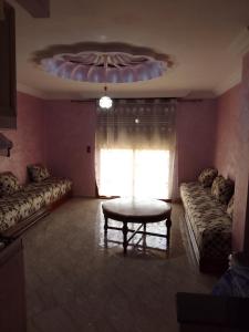 a living room with a couch and a table at Location saisonnière in Settat