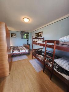 a room with two bunk beds and a hallway at Hiša Heidi in Zavrč