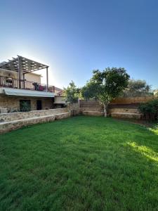 a large yard in front of a house at Marvel Sea View 3 in Akrogiali