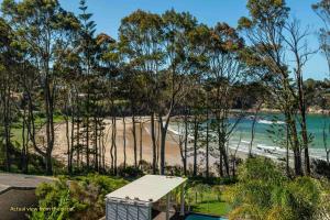 a view of the beach from the balcony of a house at Denhams Beach side holiday apartment in Batemans Bay