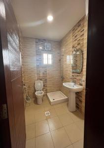 a bathroom with a toilet and a sink at هلال بن احمد للضيافة in Obhor