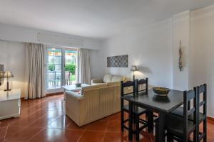 a living room with a couch and a table at Hoyo I by Ĥ - Isla Canela Golf GHHI16B2P75 in Isla Canela