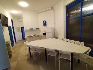 a kitchen with a table and chairs in a room at Hostel Koprivnica in Koprivnica +19 photos