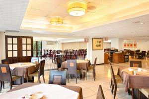 a dining room with tables and chairs in a restaurant at Sun Moon Lake Teachers' Hostel in Yuchi