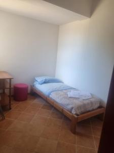 a small bedroom with a bed in a room at Costa di Mare in Monasterace +4 photos