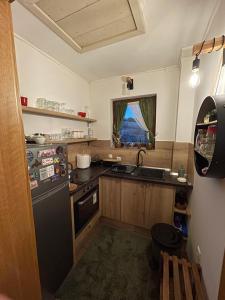 a kitchen with a black refrigerator and a sink at Vikendica Paša in Pale +14 photos