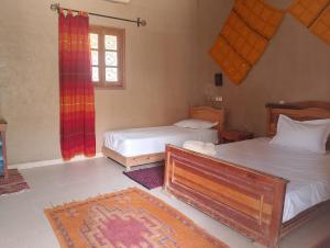 Postel nebo postele na pokoji v ubytování Hotel Riad Oasis