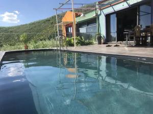 a swimming pool in front of a house at Elegant Villa with Sea View in Politika in Politiká