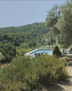 a villa with a swimming pool and a mountain at Elegant Villa with Sea View in Politika in Politiká