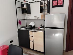 a kitchen with a refrigerator and a sink at L'oasi in Montesilvano