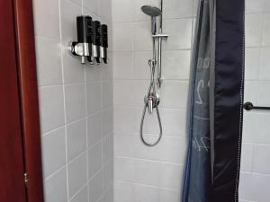 a shower with a shower head in a bathroom at L'oasi in Montesilvano