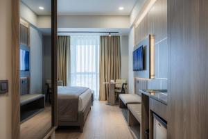 a hotel room with a bed and a desk at RENEX HOTELS in Antalya