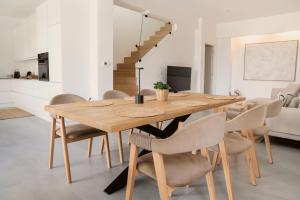 a dining room with a wooden table and chairs at IONAS Parga Villas - Adults Only in Parga +29 photos