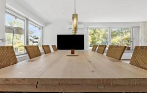 a large dining room with a large wooden table and chairs at Awesome Home In Nordborg With Wifi in Nordborg