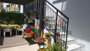 a balcony with two chairs and a table with flowers at B&B Home Sweet Home in Diano Marina