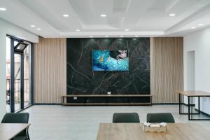 a conference room with a large screen in the ceiling at Hotel Utes in Kaji-Say
