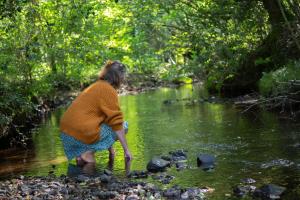 a woman standing in the water in a creek at Le Moulin des hirondelles in Pluvigner