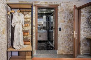 a dressing room with a dress and a mirror at Anassa Luxury Apartment 13 in Heraklio Town +5 photos