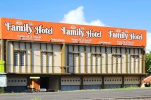 a large building with an orange sign on top of it at Family 24 Hotel near Pantai Cipatujah in Cipatujah