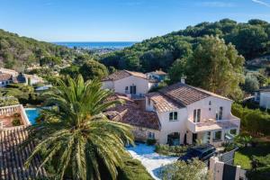 an aerial view of a house with a palm tree at Twin Luxurious Villas 8 BR Pool in Vallauris in Vallauris