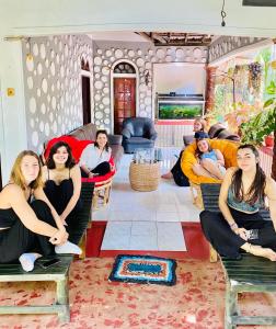 a group of women sitting on chairs in a living room at Pearl White House in Udawalawe