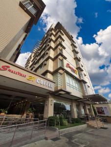 a tall building with a coffee sign on it at SMALLVILLE 21 HOTEL in Iloilo City