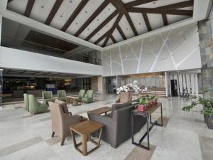 a lobby with couches and chairs in a building at Newtown Plaza Hotel in Baguio