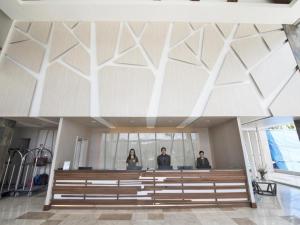 a group of three people standing in a church at Newtown Plaza Hotel in Baguio +97 photos