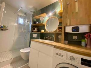 a bathroom with a sink and a toilet and a shower at Mosaic Canal - 2 bedrooms flat, 10mn walk to Paris in Pantin +15 photos