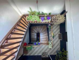 a doll house with a staircase with potted plants at Mosaic Canal - 2 bedrooms flat, 10mn walk to Paris in Pantin