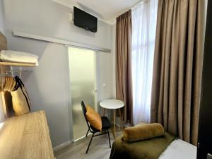 a hotel room with a bed and a chair and a window at City Hotel Storch in Cologne