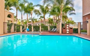 a swimming pool with a slide and palm trees at Hyatt Place at Anaheim Resort / Convention Center in Anaheim
