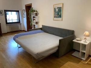 a bed in a room with a side table at Casa Gallieno nel cuore di Verona in Verona