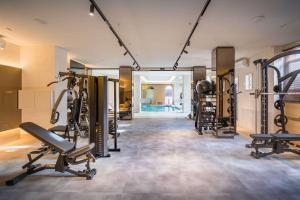 a gym with several treadmills and exercise equipment at Barceló Isla Canela in Isla Canela
