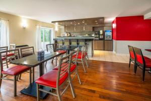 a restaurant with tables and chairs and a kitchen at Comfort Inn in Newmarket