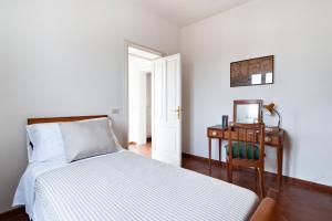 a bedroom with a bed and a desk with a mirror at Casa Salento tre R - Lecce Selection in Squinzano