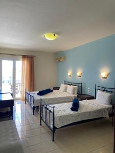 Postel nebo postele na pokoji v ubytování Zeus Paradise Hotel Ammoudia